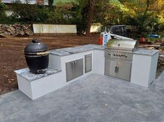 an outdoor kitchen with grill, sink and oven