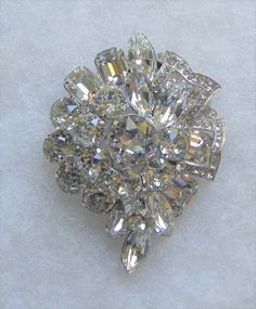 "Vintage Eisenberg crystal floral pin with multiple layers. This is in excellent, clean condition. No missing, bad, dull or yellowing stones. No noticeable wear or damage to rhodium plated silver tone frame. Measures 2 1/2\" x 2\"." Silver Crystal Brooch With Sparkling Stones, Silver Crystal Brooches With Sparkling Stones, Silver Crystal Brooch For Anniversary, Silver Crystal Brooches For Anniversary, Silver Crystal Anniversary Brooches, Glamorous Silver Brooch For Wedding, Sparkling Silver Brooch For Anniversary, Crystal Brooches With Sparkling Stones For Anniversary, Silver Sparkling Brooches For Anniversary