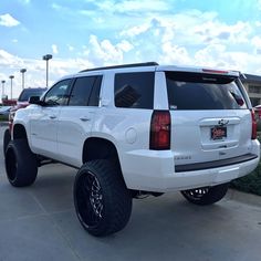 a white suv parked in a parking lot