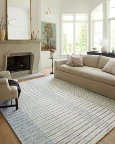 a living room filled with furniture and a fire place in the middle of the room