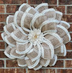 a large burlocked flower on the side of a brick wall