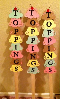 three popsicles with the words poppin's spelled on them in different colors