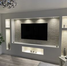 a large flat screen tv mounted to the side of a wall in a living room