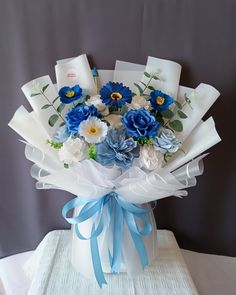 a bouquet of blue and white flowers in a vase