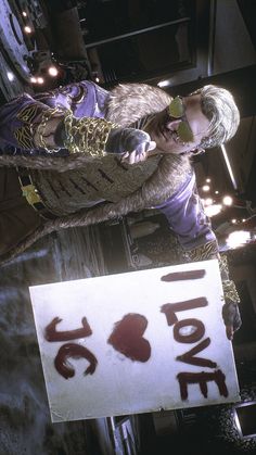 a man holding a sign that says i love you