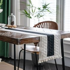 a table with a black and white runner on it