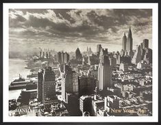 black and white photograph of new york city from the top of empire building, looking down on lower east side