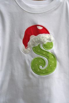 an appliqued t - shirt with the number six on it and santa's hat