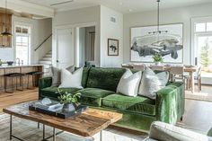 a living room filled with furniture next to a kitchen