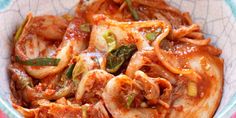 a bowl filled with pasta and sauce on top of a table