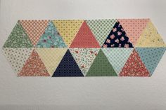 a piece of fabric that has been made into a hexagonal pattern on the wall