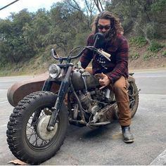 a man sitting on top of a motorcycle