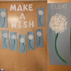 a door decorated with paper flowers and the words make a wish