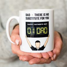 a person holding a coffee mug that says dad - there is no substitue for you