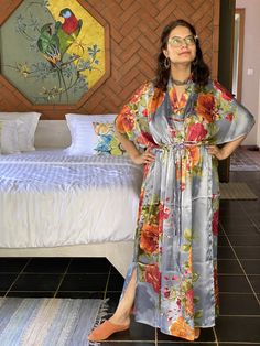 I made this Kaftan from a beautiful floral pattern in satin silk fabric. It is very soft with a nice flowy feel to it making you feel as if you are not wearing anything. It is so free flowing, that it will make you feel as if you aren't wearing anything at all ;) The beauty of the Kaftans is they will fit everyone so no need to worry about the size et all. All my Kaftans have deep necks(11-12 inches) so will fit all head sizes. However, the length of my kaftans will vary. I make all my kaftan st Summer Floral Print Kimono For Sleep, Summer Floral Print Sleep Kimono, Long Satin Summer Robe, Multicolor Floral Print Kaftan For Loungewear, Multicolor Silk Robe For Vacation, Multicolor Floral Print Beach Robe, Summer Beach Kimono In Satin, Summer Beach Satin Kimono, Multicolor Floral Print Robe For Vacation