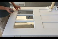 a man is sanding up the top of a kitchen counter