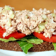 a close up of a sandwich on a plate with lettuce and tomato slices