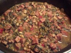 a pot filled with meat and beans on top of a stove