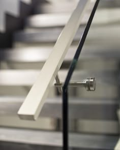 an escalator with metal handrails and white railing