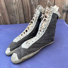 an old pair of sneakers sitting on top of a blue mat