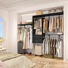 an open closet with clothes hanging on the wall, and a bed in the foreground