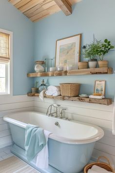 a bath tub sitting under a window next to a shelf