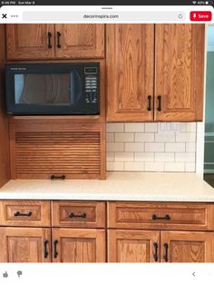 a kitchen with wooden cabinets and white tile counter tops is shown on the webpage