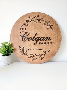 the colgan family sign is next to a potted plant