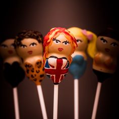 there are many cake pops with the faces of people on them