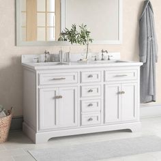 a white bathroom vanity with two sinks and mirrors