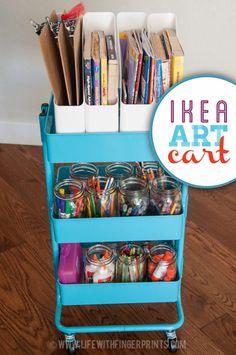 a blue cart filled with lots of craft supplies