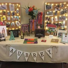 a table topped with pictures and cards under lights