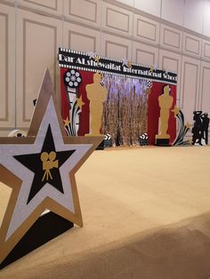 a star is placed on top of a table in front of an award ceremony backdrop