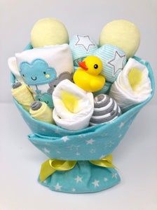 a blue and white basket filled with baby items