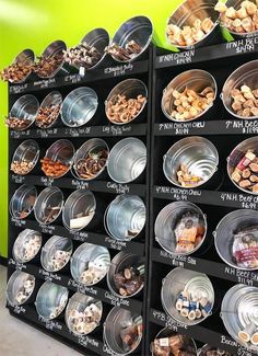 a display case filled with lots of different types of nuts and other food in plastic containers