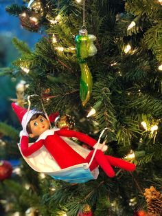 an elf is hanging on the christmas tree