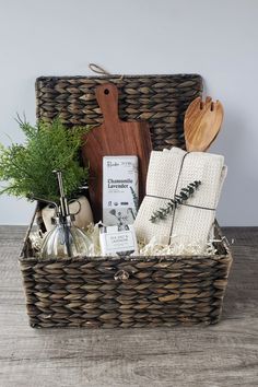 a wicker basket filled with kitchen items on top of a wooden table next to a cutting board