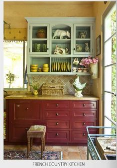 a kitchen filled with lots of cupboards covered in dishes and vases on top of them