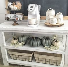 the coffee bar is decorated with pumpkins and gourds for fall decorating