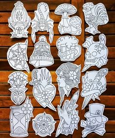 some stickers that are sitting on top of a wooden table with wood slats