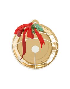 a paper plate with a red ribbon on it and an ornament hanging from the side