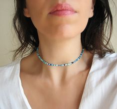 Seed Bead Choker, Beaded Necklace, Blue Necklace Mix turquoise, teal, navy blue, seafoam and aqua beaded choker necklace with glass tiny seed beads. DESCRIPTION Made from 2mm glass seed beads and closes with a silver plated clasp and 2 inches adjustable chain. SIZE Necklace is 13 inches and can be adjusted up to 15 inches with a 2 inches extender chain. Please let me know if you would like a different length. WRAPPING - All ZafireniaDainty jewelry arrive gift wrapped in a cute bag or box ready f Blue Beaded Choker With Faceted Beads, Blue Faceted Beads Choker Necklace, Blue Single Strand Choker For Gift, Blue Single Strand Choker As Gift, Blue Single Strand Choker With Round Beads, Adjustable Blue Gemstone Beads Choker, Beaded Necklace Blue, Dainty Necklace Layered, Seed Bead Choker