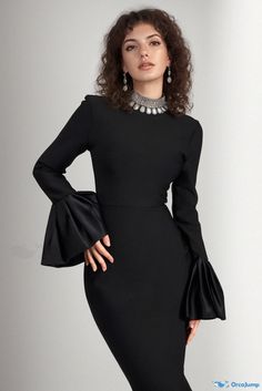 a woman wearing a black dress with bell sleeves and an open neckline is posing for the camera