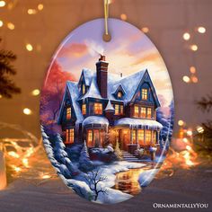 a christmas ornament with a house on the front and lights in the back