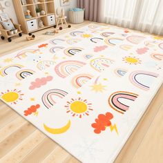 a child's room with wooden floors and colorful rugs on the floor in front of a window