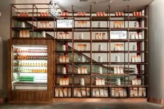 the shelves are filled with many different types of condiments and drinks in glass cases