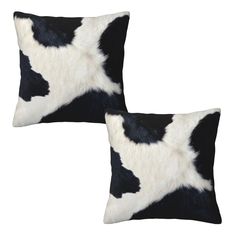 two black and white cow hide pillows