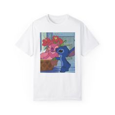 a white t - shirt with an image of stitch and stitch in front of flowers