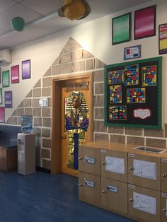 an egyptian themed classroom is decorated with legos and paper machons on the wall