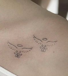 the back of a woman's stomach with two birds on it and paw prints